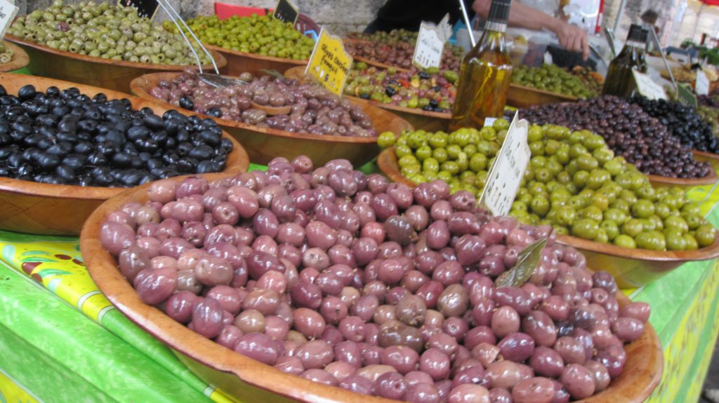 Many baskets of olives for sale